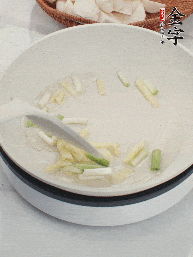 鍋中油五成熱，下蔥白、姜片爆香。