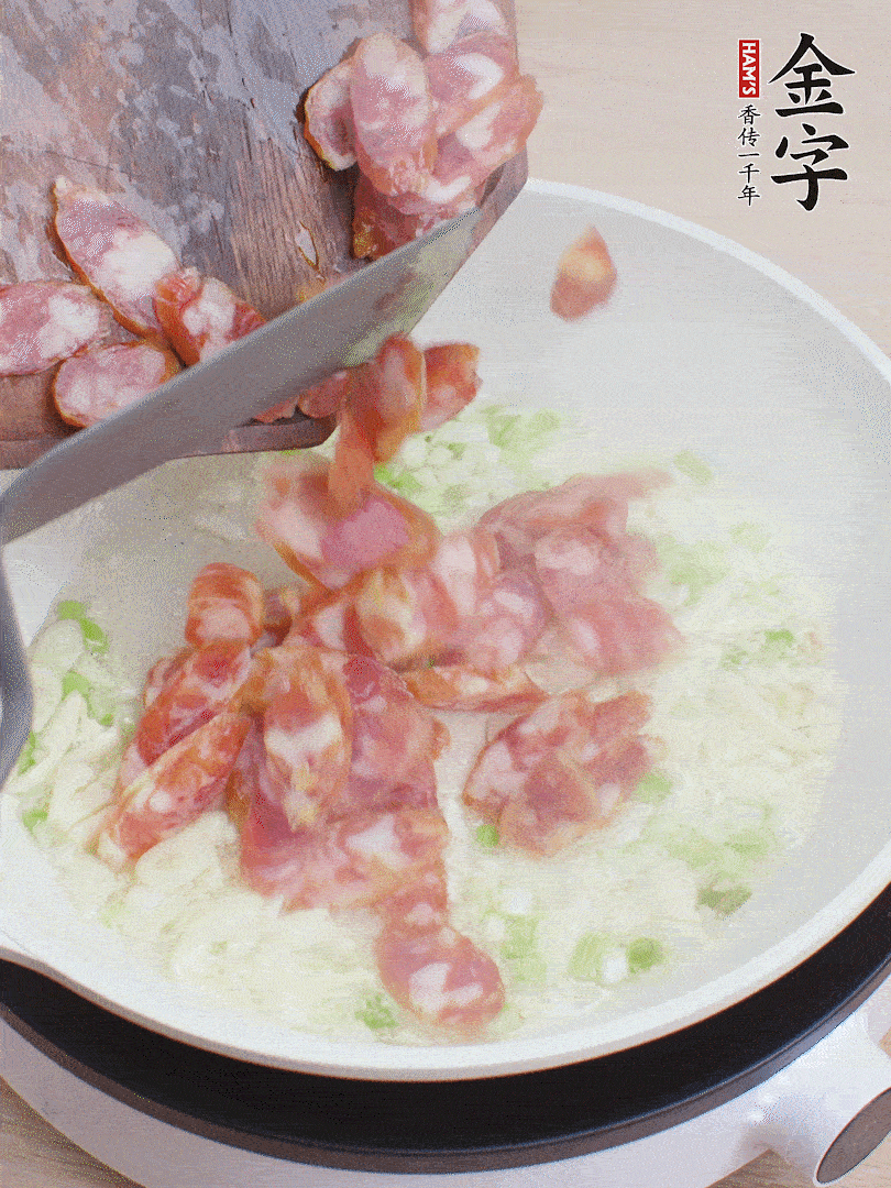 油5成熱，蒜末、蔥白爆香，下香腸炒出香味。